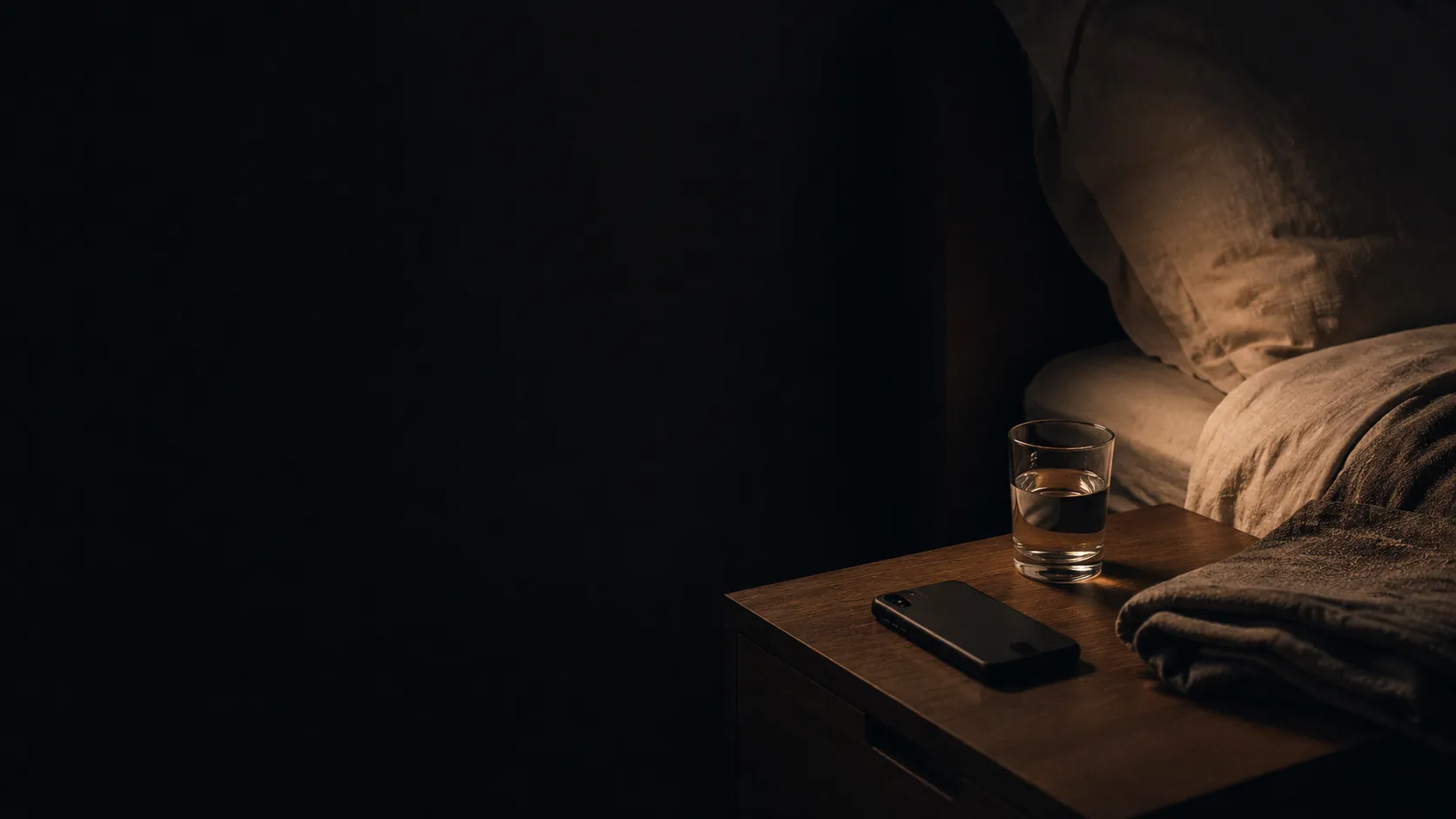 A quiet nighttime room with soft darkness, symbolizing Catholic night prayer and surrender before sleep.